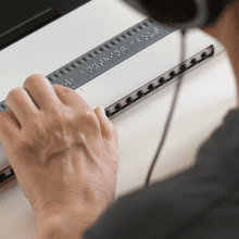 man using braille screen reader