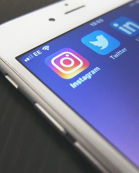 Smart phone with social media apps shown. What are the benefits of social media for businesses?